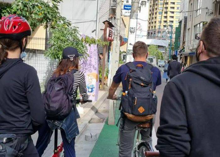 Four people cycling through the streets of Tokyo on a unique city bike tour.